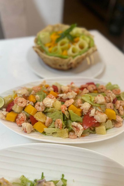 A plate of grilled fish with vegetables