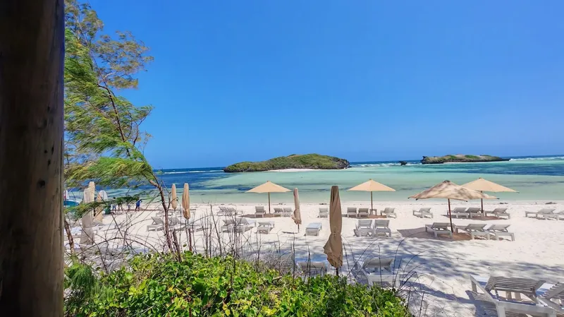 Sun loungers and umbrellas on the white sand