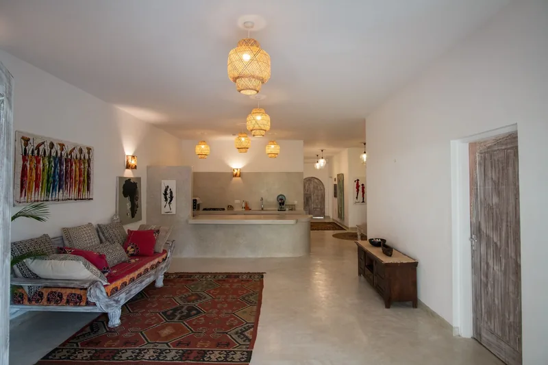 Villa Miren's open-plan living room with a carved lantern and the kitchen behind