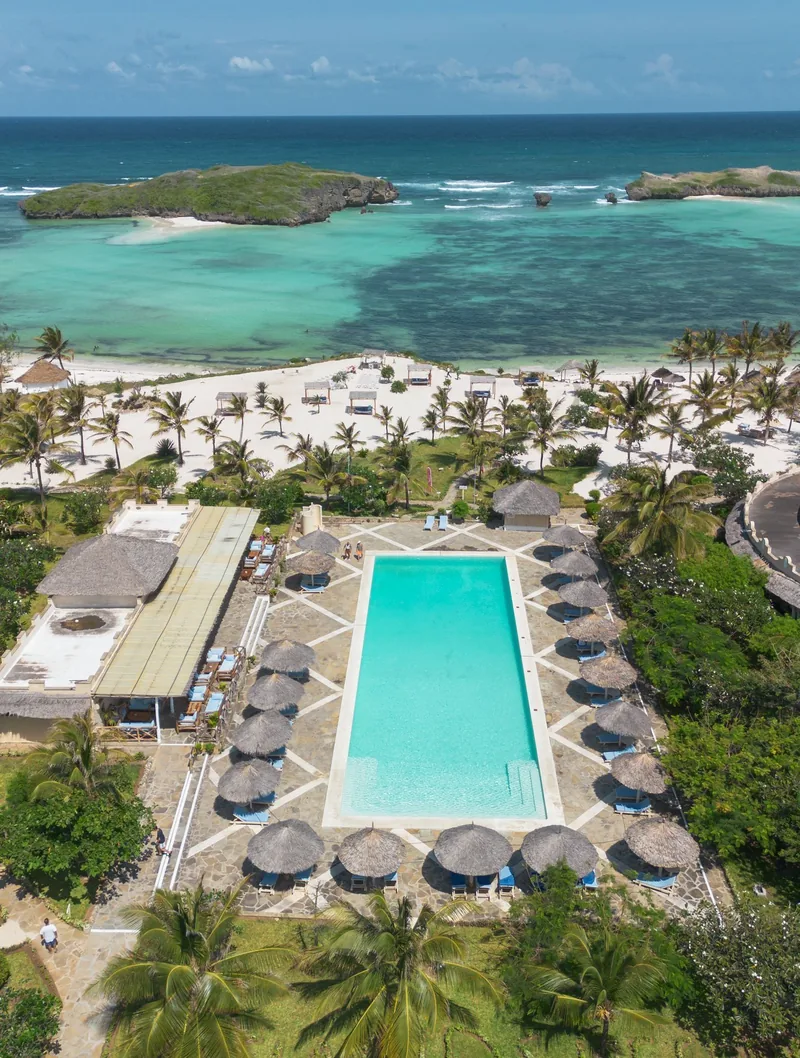 Aerial view from the shared pool at Papa Remo Village out to the beach and islets
